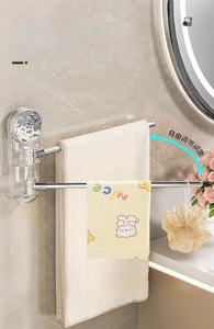 Detail of wall-mounted rotating towel rack with adjustable stainless steel arms