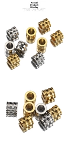 Detailed view of gold and silver stainless steel spacer beads with ringed texture