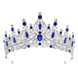 Detailed close-up of a silver tiara featuring large blue crystals and white rhinestones