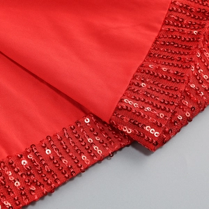 Macro shot of red sequin detailing and delicate fabric texture on an evening dress
