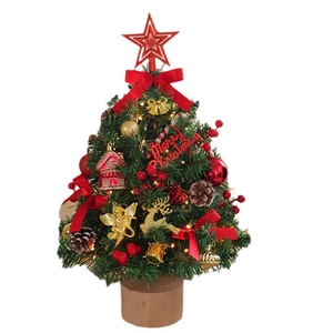 Mini tabletop Christmas tree with LED lights and festive ornaments on wooden base