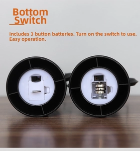 Detail view of the bottom switch and battery compartment with three button cells included