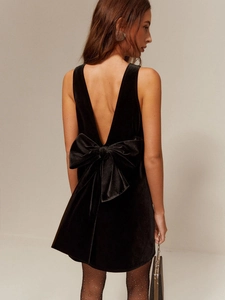 Elegant black velvet backless mini dress featuring a signature oversized bow detail