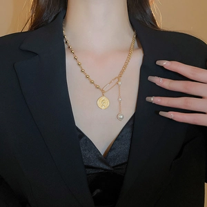 Vintage gold necklace featuring an Elizabeth II coin pendant, pin detail and faux pearl