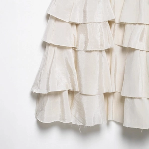 Elegant ivory tiered maxi skirt in silky fabric with a high-gloss pearlescent finish