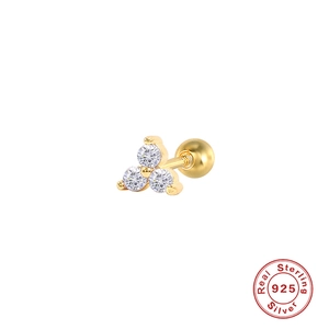 Close-up of golden geometric triangle ear stud with triple clear stones and screw back
