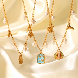Marine style gold layered necklace with pearls, starfish and shell pendants on silk