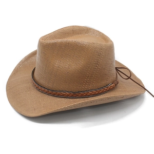 Detail view of khaki straw cowboy hat with brown braided leather band and silver metal studs