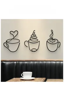 Detailed view of three minimalist black metal wire coffee cup wall art pieces on a wall
