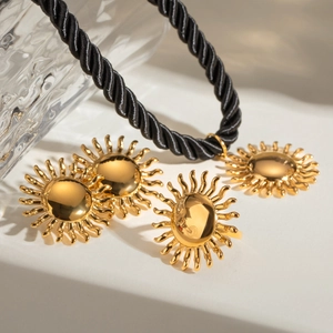 Detailed view of sunburst gold jewelry set including earrings, ring and rope necklace