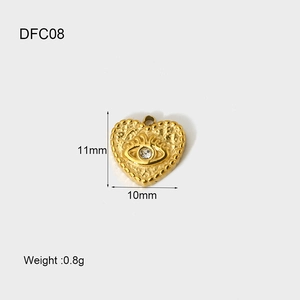 Detail view of 14K gold-plated heart pendant with evil eye motif and dimension data