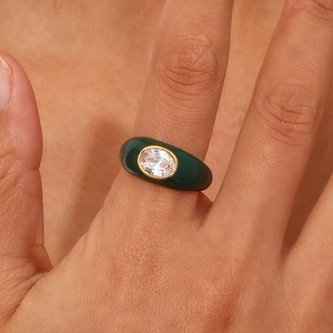 Detail of 18K gold plated stainless steel ring with green enamel and oval zircon gem