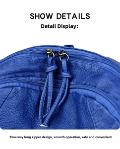 Detail view of double-way metal zipper with long leather puller on blue backpack