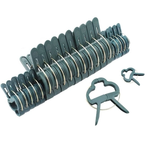 Garden plant support clips in dark green plastic with metal rings for climbing vines