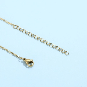 Detailed view of the golden lobster clasp and adjustable extension chain on the necklace