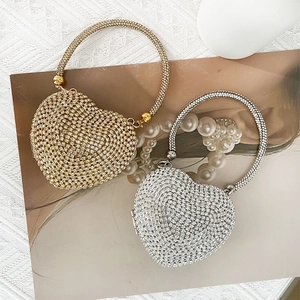 Macro detail of gold and silver heart-shaped evening bags with encrusted rhinestones