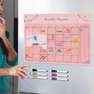 Acrylic monthly planner on fridge with six colorful magnetic markers for organization