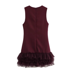 Detail of burgundy sleeveless dress featuring a mesh splice hem and hidden back zipper