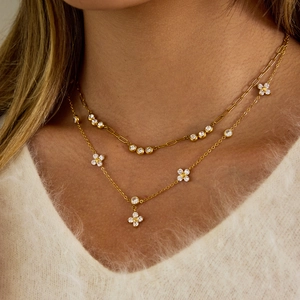Double-layer 18k gold plated clover necklace with zircon pendants on white sweater