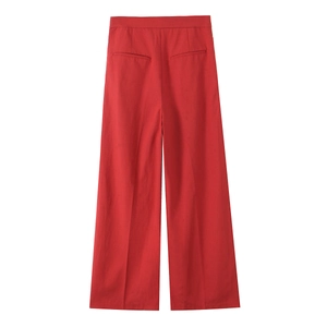Detail of red wide-leg trousers featuring clean back suit-style pockets on woven fabric