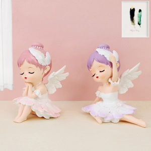 Detail of resin ballet angel figurines with wings for desktop or cake decoration