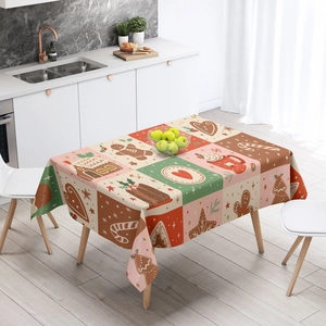 Close-up of festive Christmas tablecloth with gingerbread house and candy cane patterns