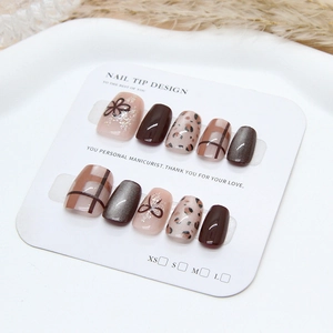 Detail view of 10-piece leopard and checkered press-on nails on a white display card