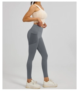 Detail of high waisted yoga leggings in dark grey with functional side mesh pockets
