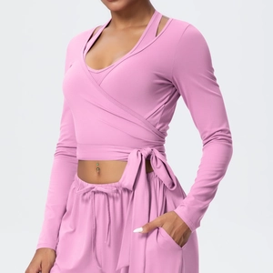 Pink yoga set featuring cross-tie long sleeve top and drawstring wide-leg pants
