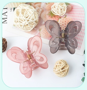 Detail of pink and grey transparent butterfly hair claws with elegant hollow wings