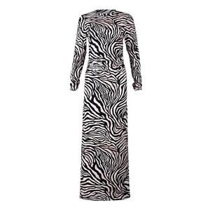 Close-up of zebra print maxi dress with pink accents and slit detail in soft knit fabric