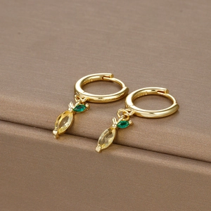 Macro detail of gold carrot earrings with yellow and green crystals on S925 silver