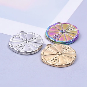 Polished 18k gold and silver citrus slice pendants in three distinct metallic finishes