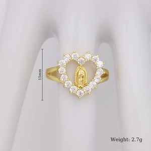 Detail view of gold heart ring with Mary relief and clear crystals on a white hand model