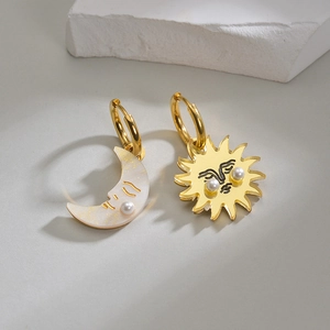 Asymmetric gold sun and moon earrings with pearls and pearl luster finish