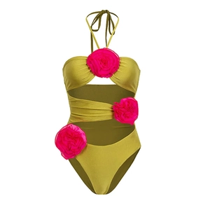 Detail of pink 3D flower decorations on an olive green cutout one-piece swimsuit