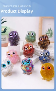 Detail showing various colorful resin owl figurines with gold leaf and crystal accents