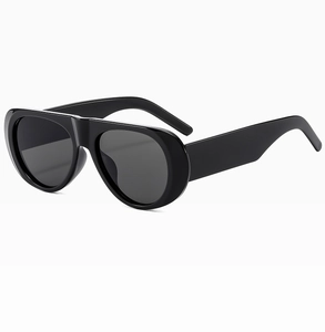 Side view of sleek black oval sunglasses with high gloss finish on white background