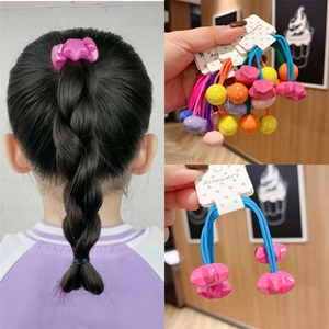 Detailed view of colorful star and ball hair ties shown on a model and in packaging