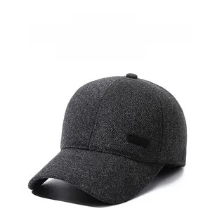 Close-up of thick wool texture and sport label on dark grey ear protection baseball cap