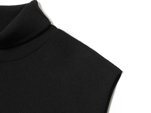 Detailed view of black turtleneck knit dress featuring premium ribbed fabric texture