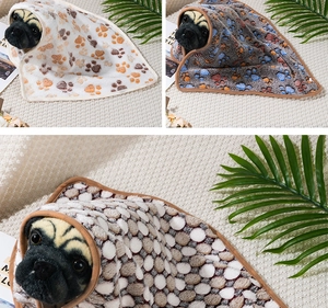 Detail of plush paw print pet blankets in various colors for dogs and cats