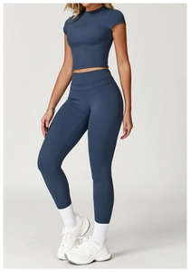 Close-up of dark blue athletic yoga set showing moisture-wicking brushed fabric texture