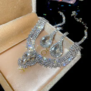 Detail of tear-drop crystal jewelry set featuring layered rhinestone necklace and earrings