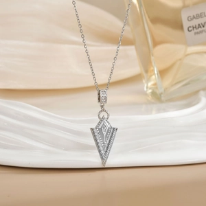 Elegant double diamond rhombus V-shaped silver necklace on a white display stand