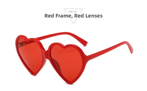 Close-up of heart-shaped sunglasses with stylish red frames and matching red lenses