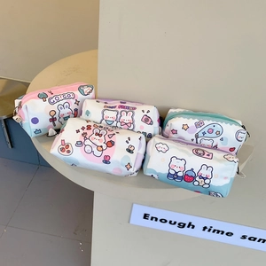 Detailed top view of assorted canvas pencil cases with cute cartoon prints and metal zippers