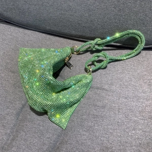 Detailed view of green rhinestone handbag with sparkling crystals and knotted handle