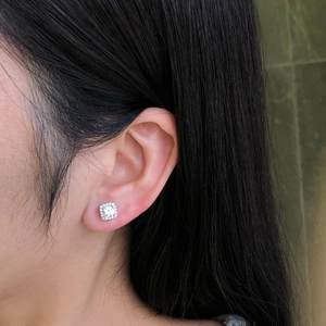 Close-up of a model wearing a small silver geometric square zircon stud earring