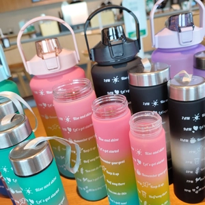 Detail view of colorful gradient sports water bottles with time markers and strap